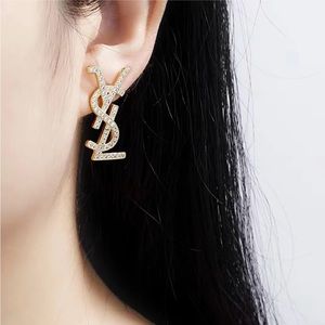 Stainless steel earrings YSL shaped. Gold plated with diamond needle